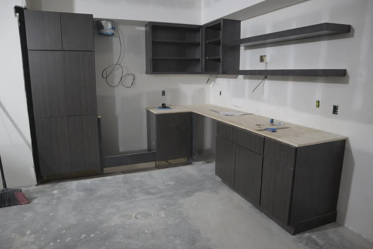 Modern dark kitchen cabinets and shelving in San Diego